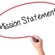 Women Hand writing Mission Statement with black marker on visual screen. Isolated on white. Business, technology, internet concept. Stock Photo